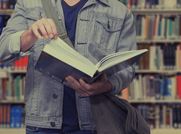 image of a man flipping through a book page