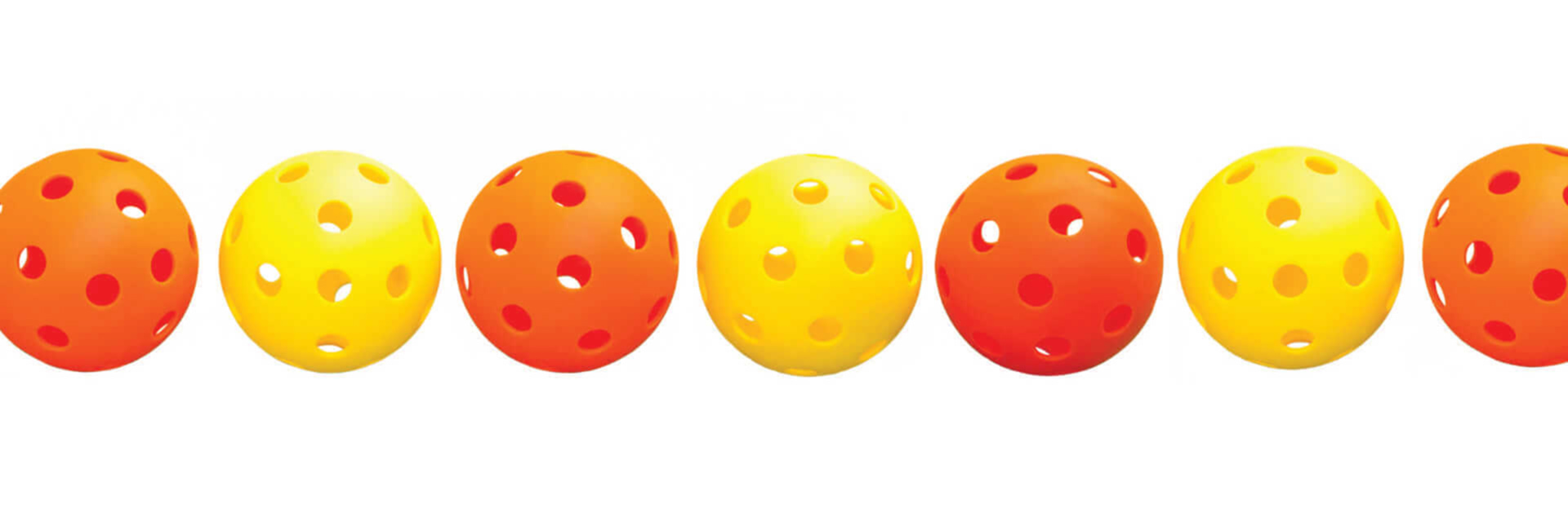 image of four perforated pickleballs in alternating orange and yellow colors lined up against a white background