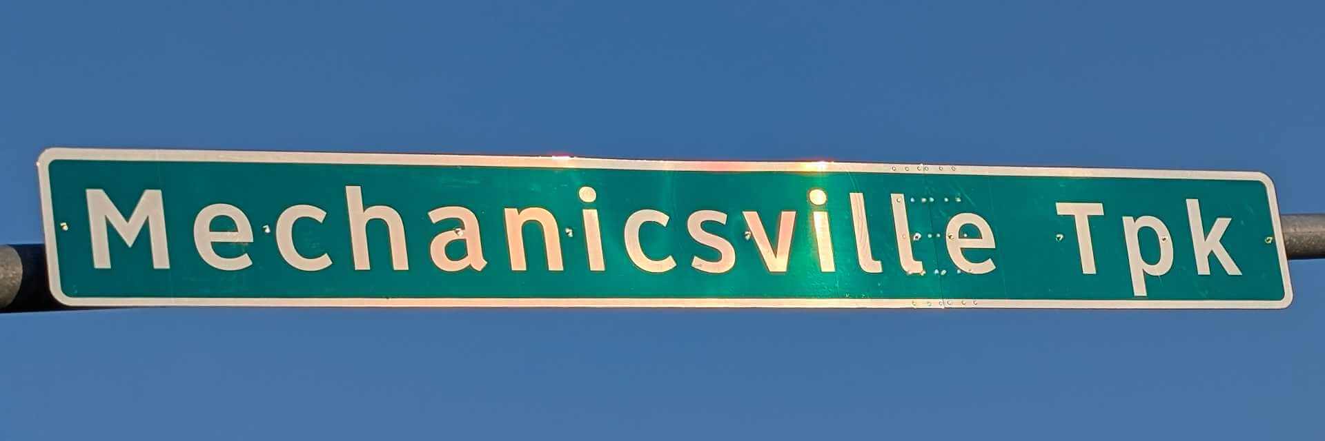 image of a horizontal street sign with the words mechanicsville tpk